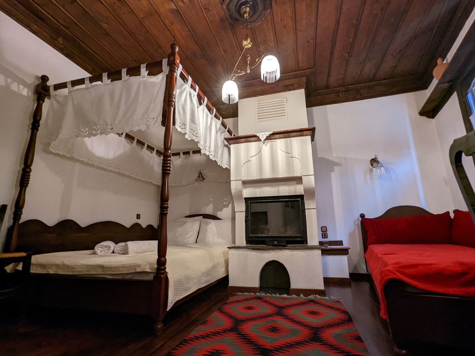 Archontiko room — handcrafted canopy bed dressed in white embroidery
