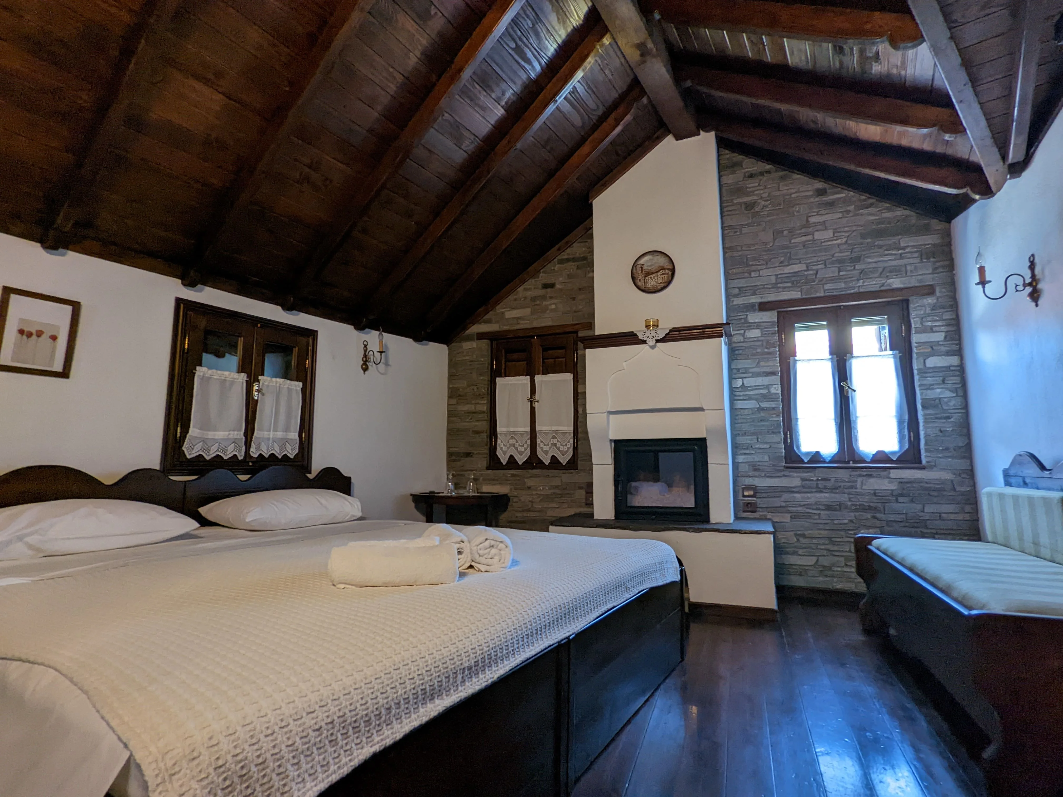 Petrino room with warm stone wall and fireplace
