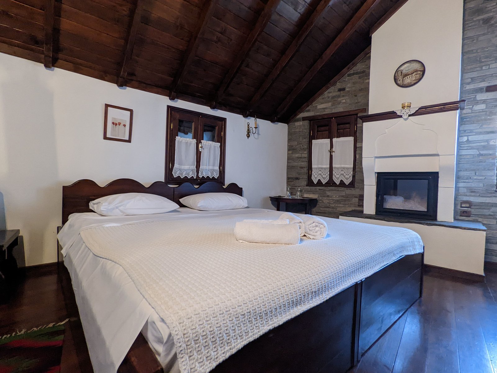 Stone fireplace in a cosy mountain guesthouse room