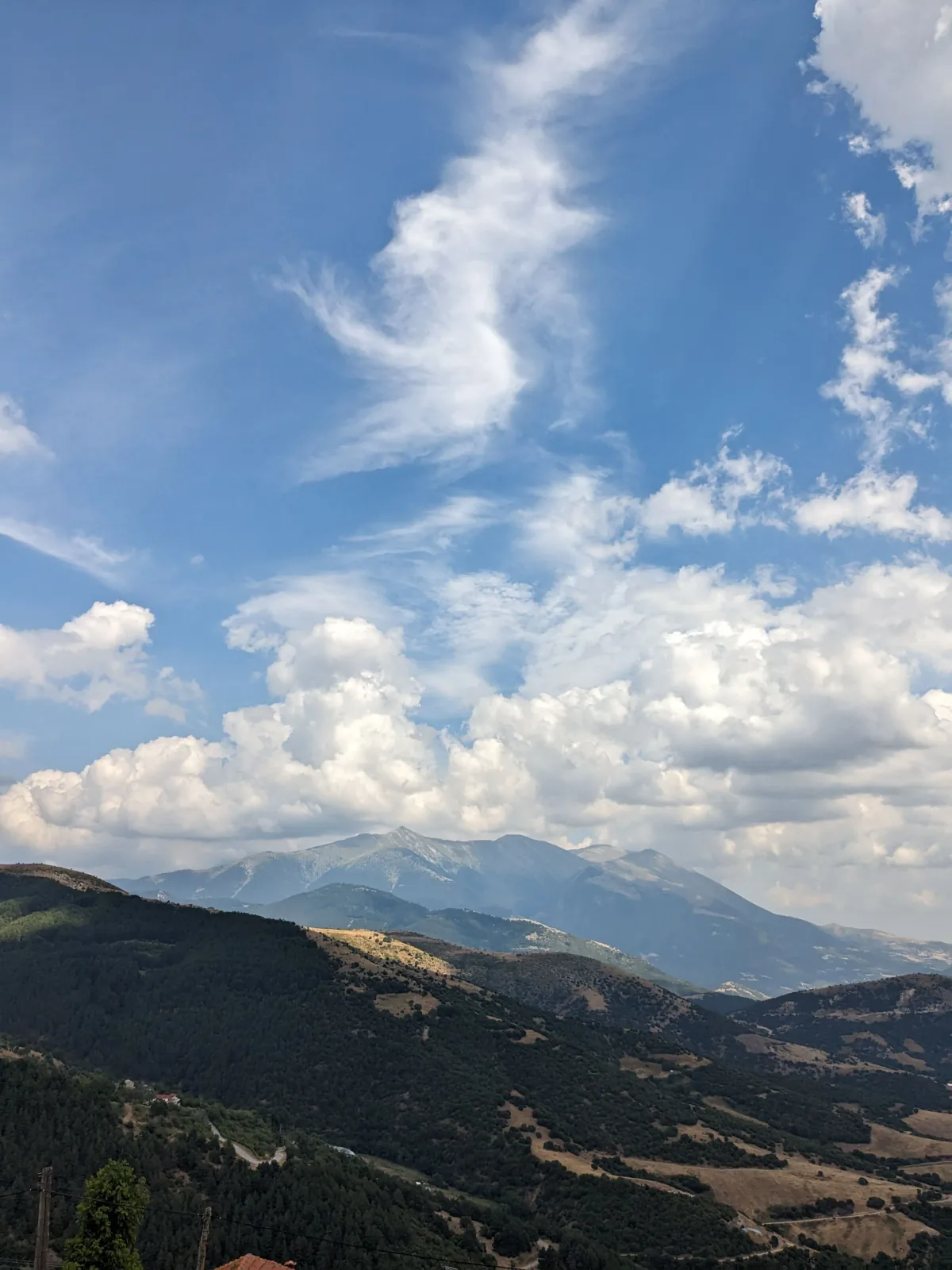 Rocky alpine summit with panoramic views above the clouds on a mountain peak
